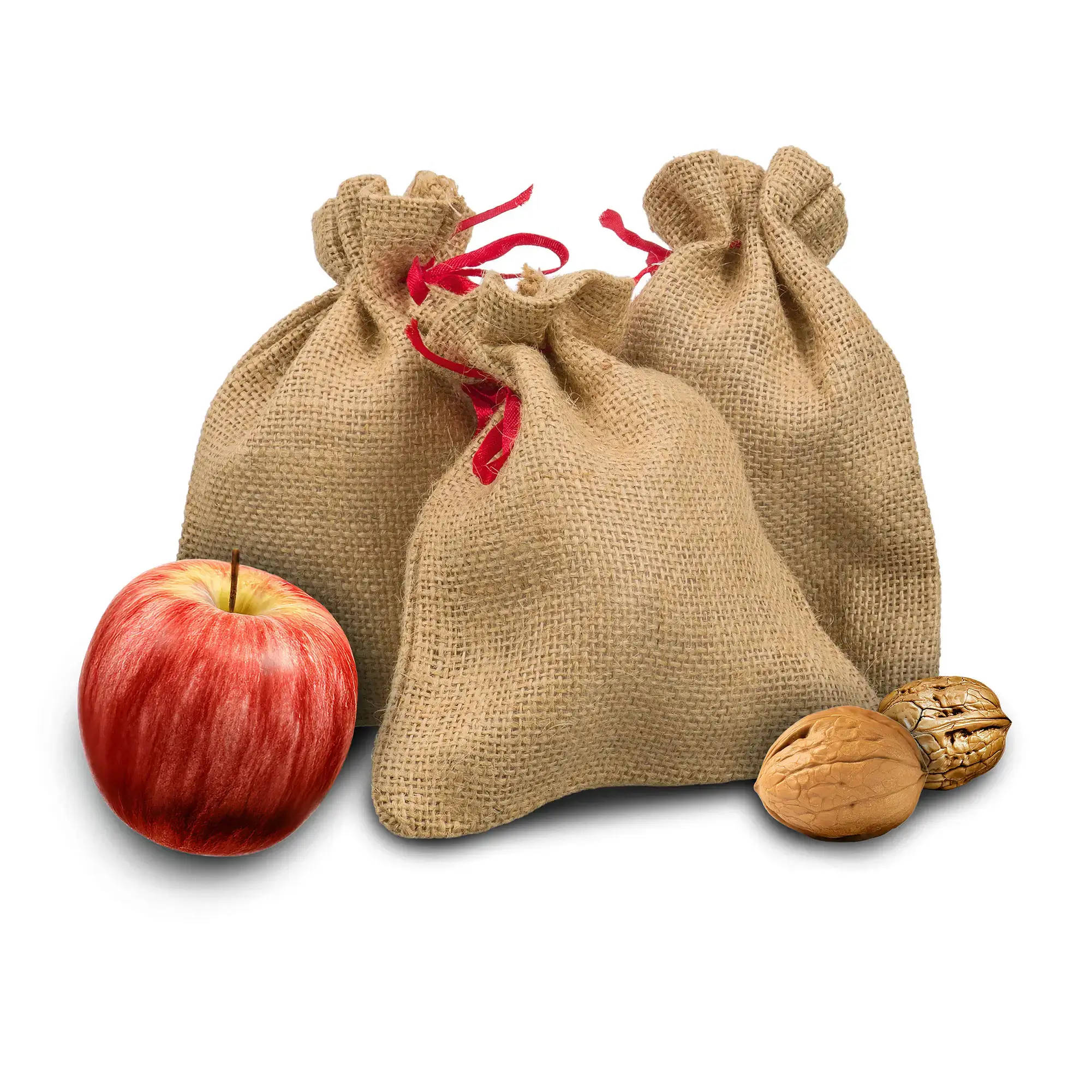 Drei naturfarbene Jutebeutel mit rotem Zugband, daneben ein roter Apfel und zwei Walnüsse.