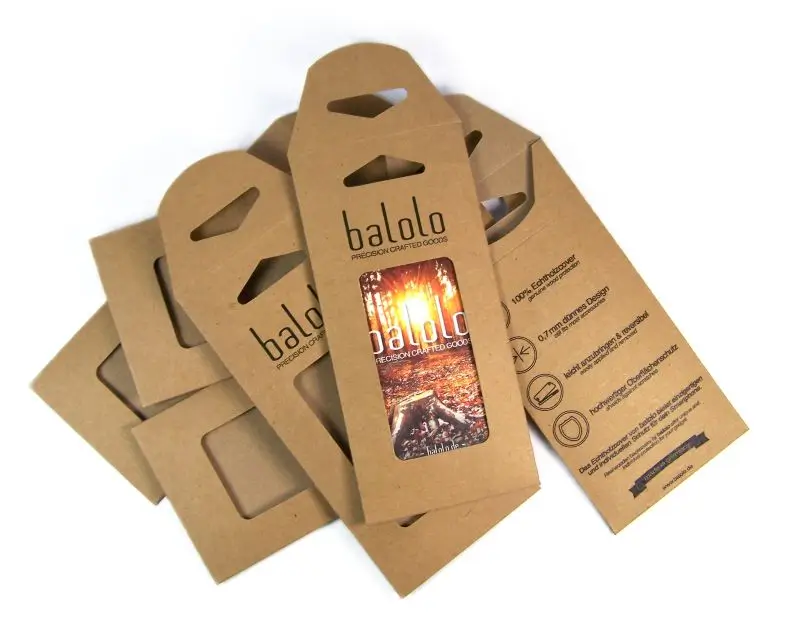 Brown cardboard packaging with viewing window and Eurohole hanger, some with balolo print, stacked on a white background.